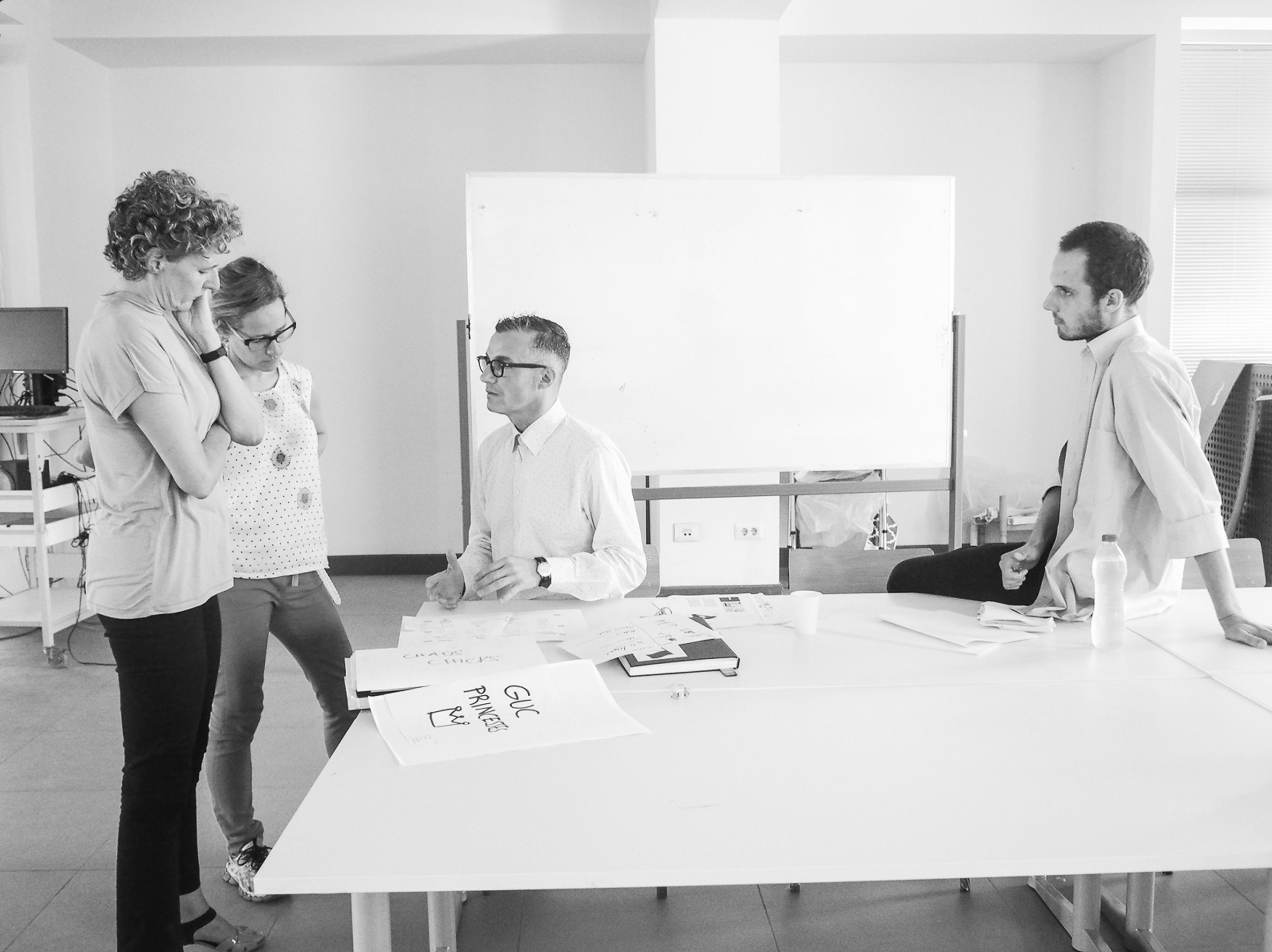 collaborators reviewing best arabic posters design sheets